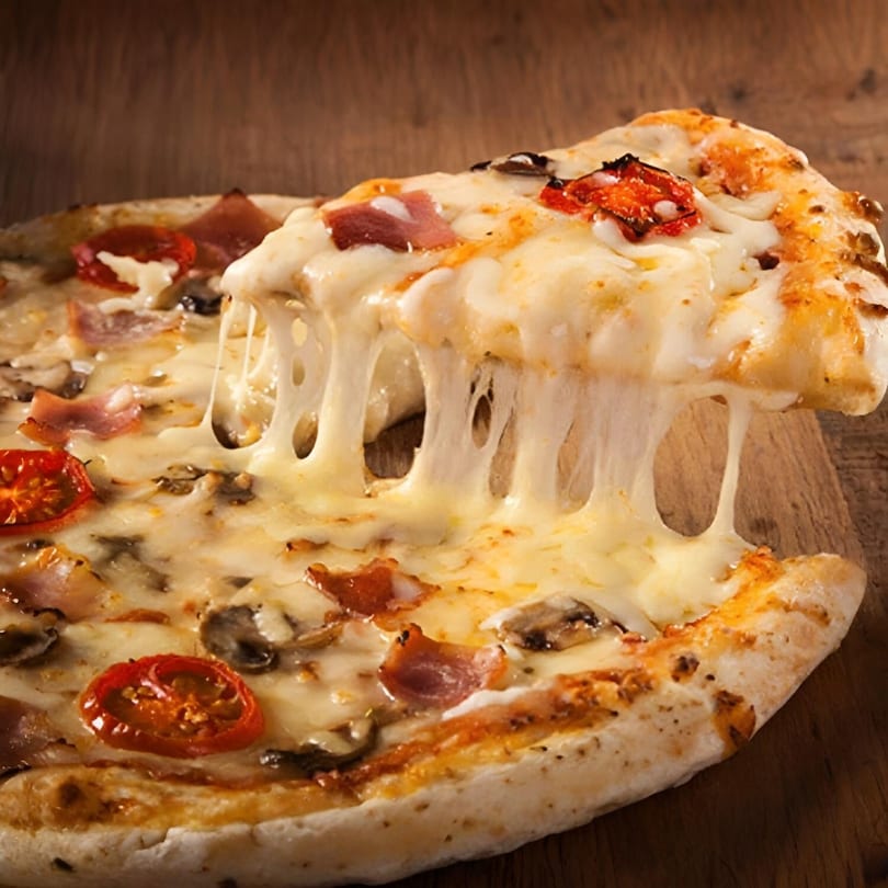 A slice of Spinners Pizza & Pasta pizza with melted cheese stretching from the pie.